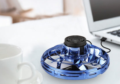  Toupie volante bleue reliée par un câble USB à un ordinateur portable .